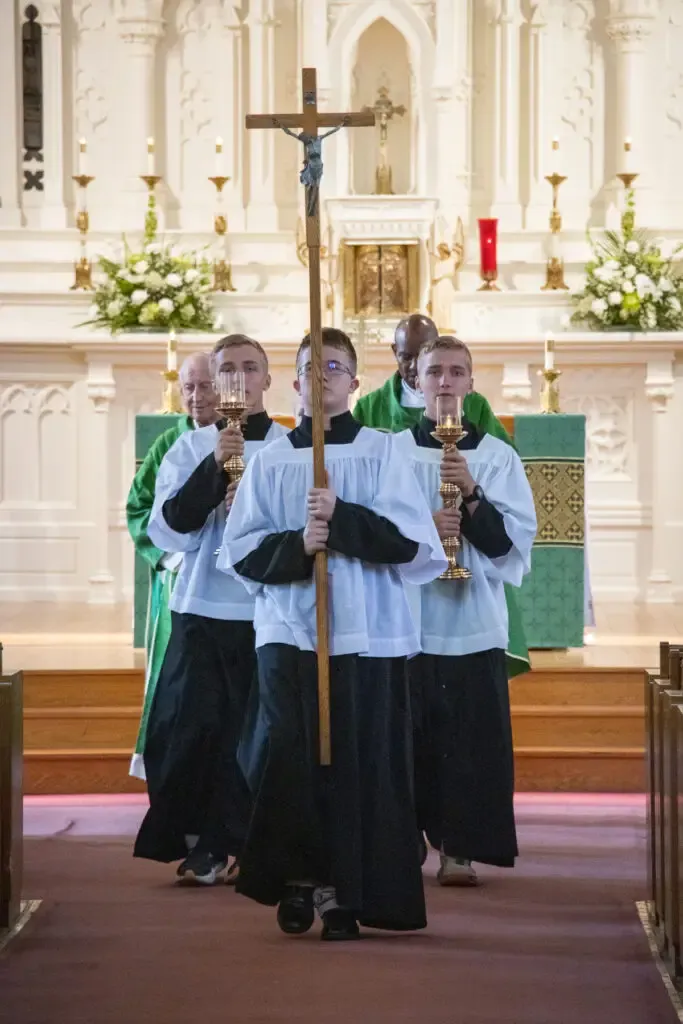 Altar servers process with the crucifix at St. Mary Church